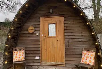 Camping pod with a small wooden porch area Camping pod with a small wooden porch area