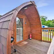 Exterior view of the Log Pods (dog friendly) with an outdoor BBQ