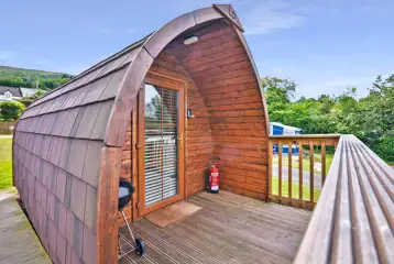 Exterior view of the Log Pods (dog friendly) with an outdoor BBQ