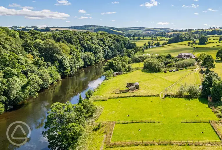 Aerial of Drybeck Farm on the banks of the River Eden with wild swimming welcome