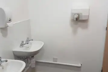 Sinks in the shared bathrooms with hand dryers Sinks in the shared bathrooms with hand dryers