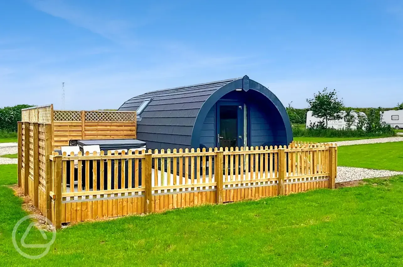 Ensuite glamping pod with a fenced-off private decked area and a hot tub