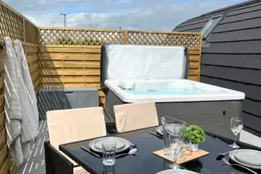 Private hot tub and seating area with table and chairs