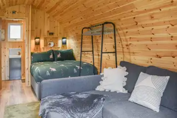 Glamping pod interior with a double bed and double sofa bed (bedding included) Glamping pod interior with a double bed and double sofa bed (bedding included)