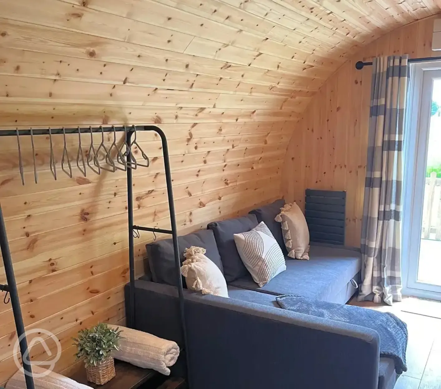 Ensuite glamping pod double L-shape sofa bed with bedding provided