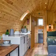 Ensuite glamping pod interior with a double bed and double sofa bed Ensuite glamping pod interior with a double bed and double sofa bed