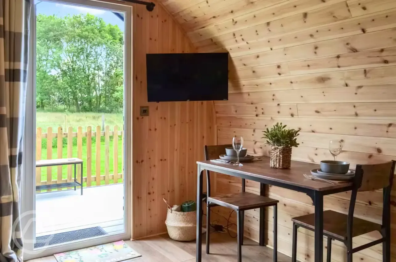 Ensuite glamping pod dining area and TV