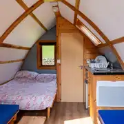 Glamping pods with a double bed, bench seating and an ensuite toilet Glamping pods with a double bed, bench seating and an ensuite toilet