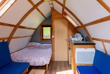 Glamping pods with a double bed, bench seating and an ensuite toilet Glamping pods with a double bed, bench seating and an ensuite toilet