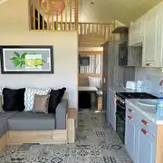 Hill top lodge interior with a double sofa bed, kitchen and mezzanine bedroom