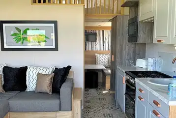 Hill top lodge interior with a double sofa bed, kitchen and mezzanine bedroom Hill top lodge interior with a double sofa bed, kitchen and mezzanine bedroom