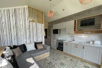 Hill top lodge interior with a double sofa bed, kitchen and mezzanine bedroom Hill top lodge interior with a double sofa bed, kitchen and mezzanine bedroom