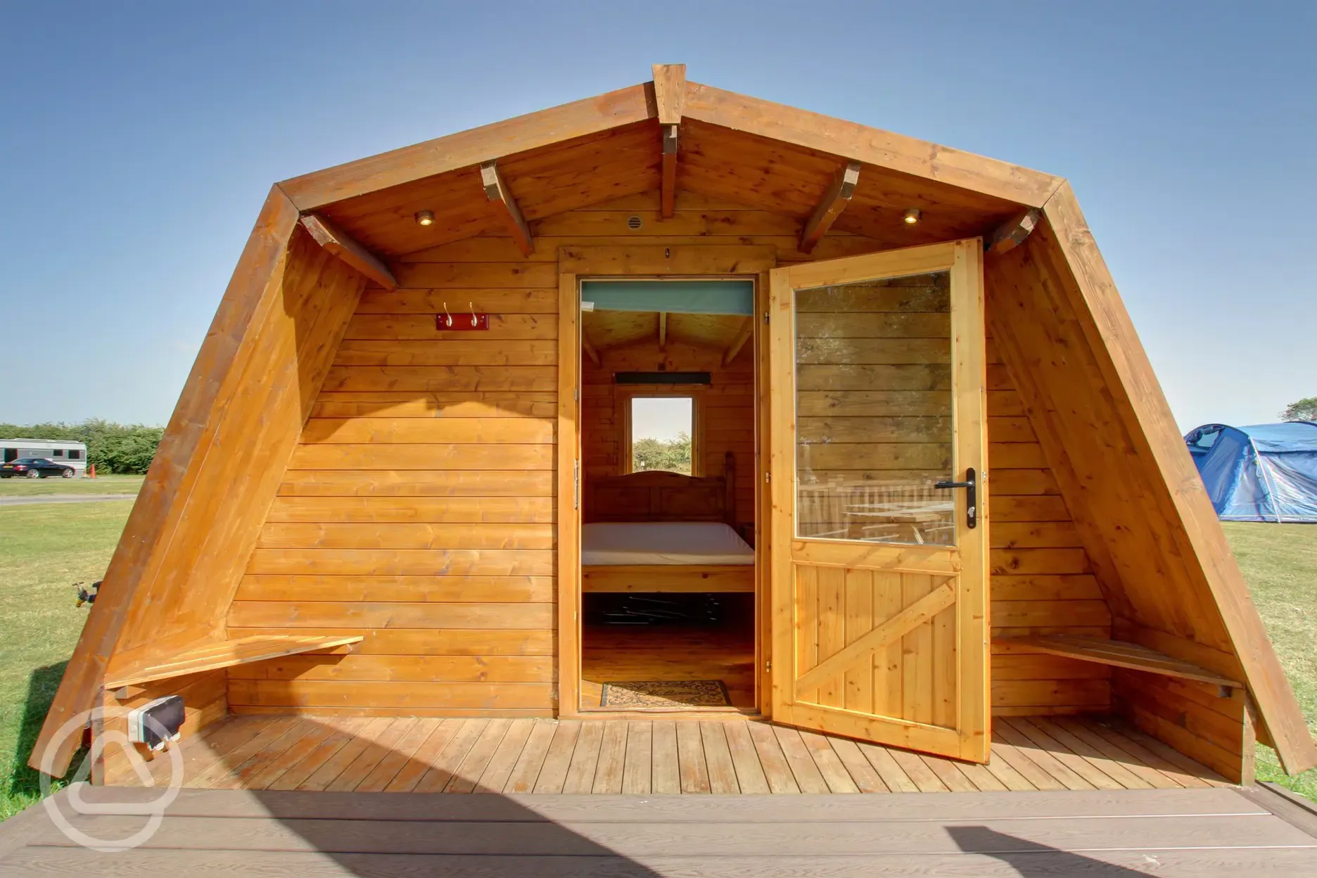 Standard glamping pod with heating, electric, two single beds and a camp bed