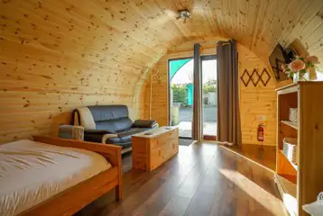 Original pod interior with double bed and sofa