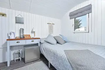 Large pods with a double bed, and a single trundle bed that turns into a king