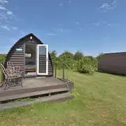 Daisy, Jasmine, and Lily camping pods exterior with a small deck area Daisy, Jasmine, and Lily camping pods exterior with a small deck area