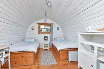 Poppy camping pod interior with twin beds (bedding included)