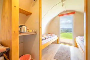 Camping pod interior with four single beds and a kettle Camping pod interior with four single beds and a kettle