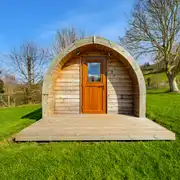 Heated camping pod exterior with a small decking