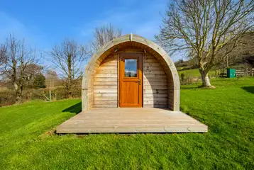 Heated camping pod exterior with a small decking Heated camping pod exterior with a small decking