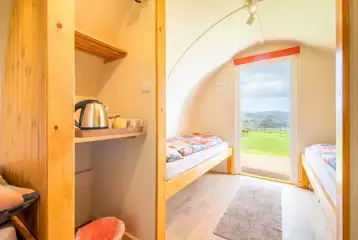 Camping pod interior with four single beds and a kettle Camping pod interior with four single beds and a kettle