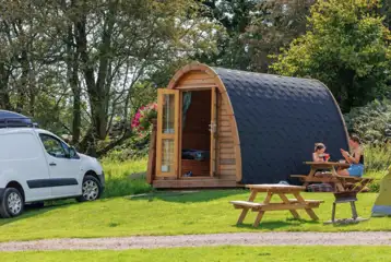Camping pod exterior with outdoor seating and 10 amp electric