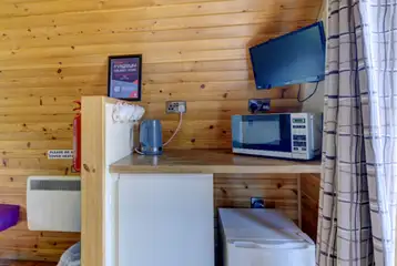 Large hiker pod interior with fridge, mugs, kettle and microwave Large hiker pod interior with fridge, mugs, kettle and microwave