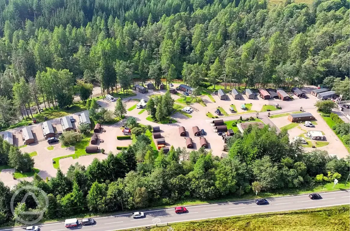 Bird's eye view of Tyndrum Holiday Park surrounded by woodland Bird's eye view of Tyndrum Holiday Park surrounded by woodland