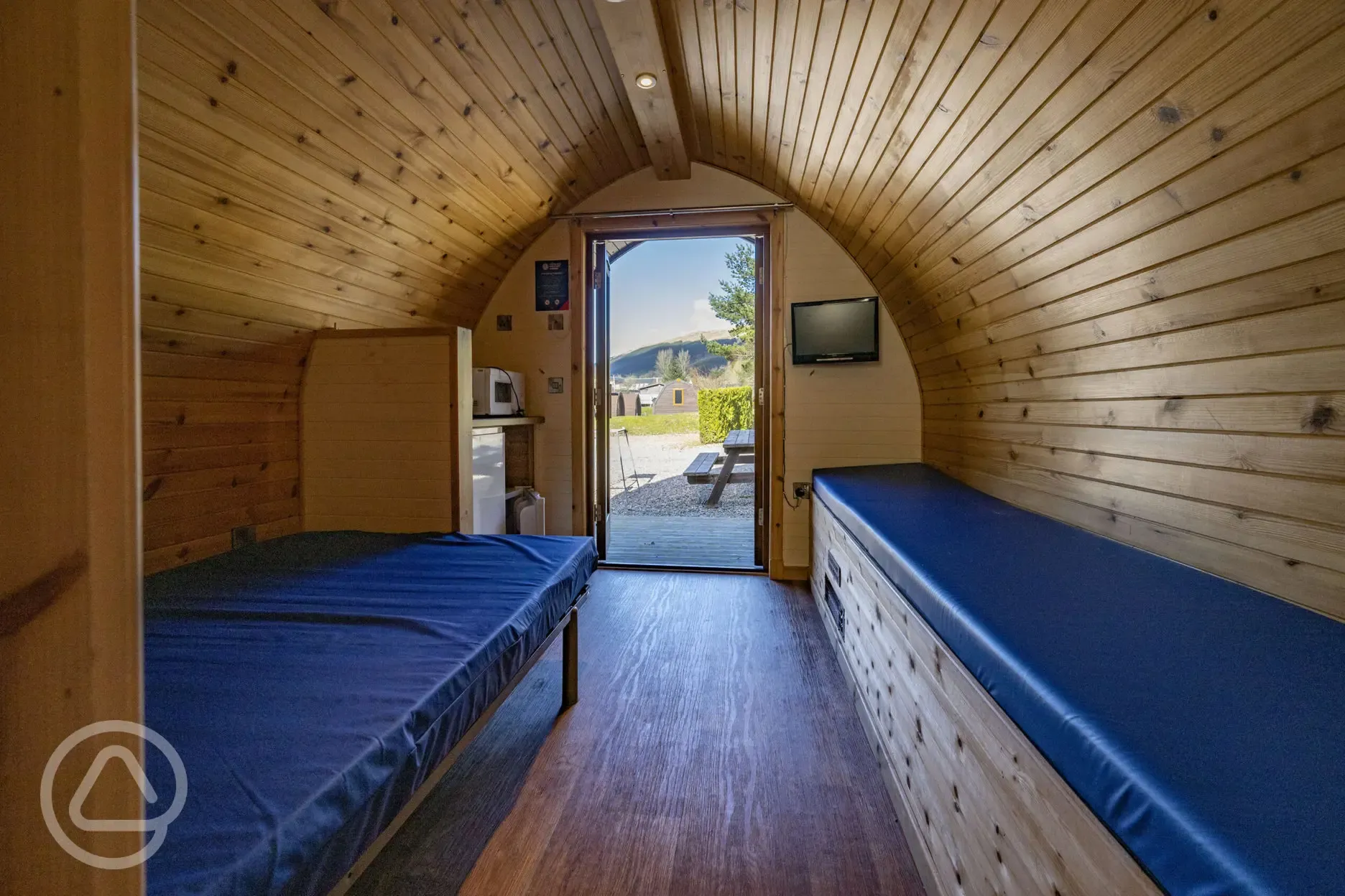 Small ensuite hiker pod interior with TV and mountain views Small ensuite hiker pod interior with TV and mountain views