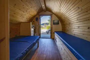 Small ensuite hiker pod interior with TV and mountain views Small ensuite hiker pod interior with TV and mountain views