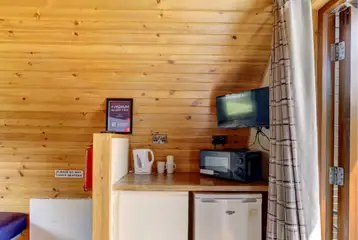 Large hiker pod with sofa bed interior with fridge, mugs, kettle and microwave Large hiker pod with sofa bed interior with fridge, mugs, kettle and microwave