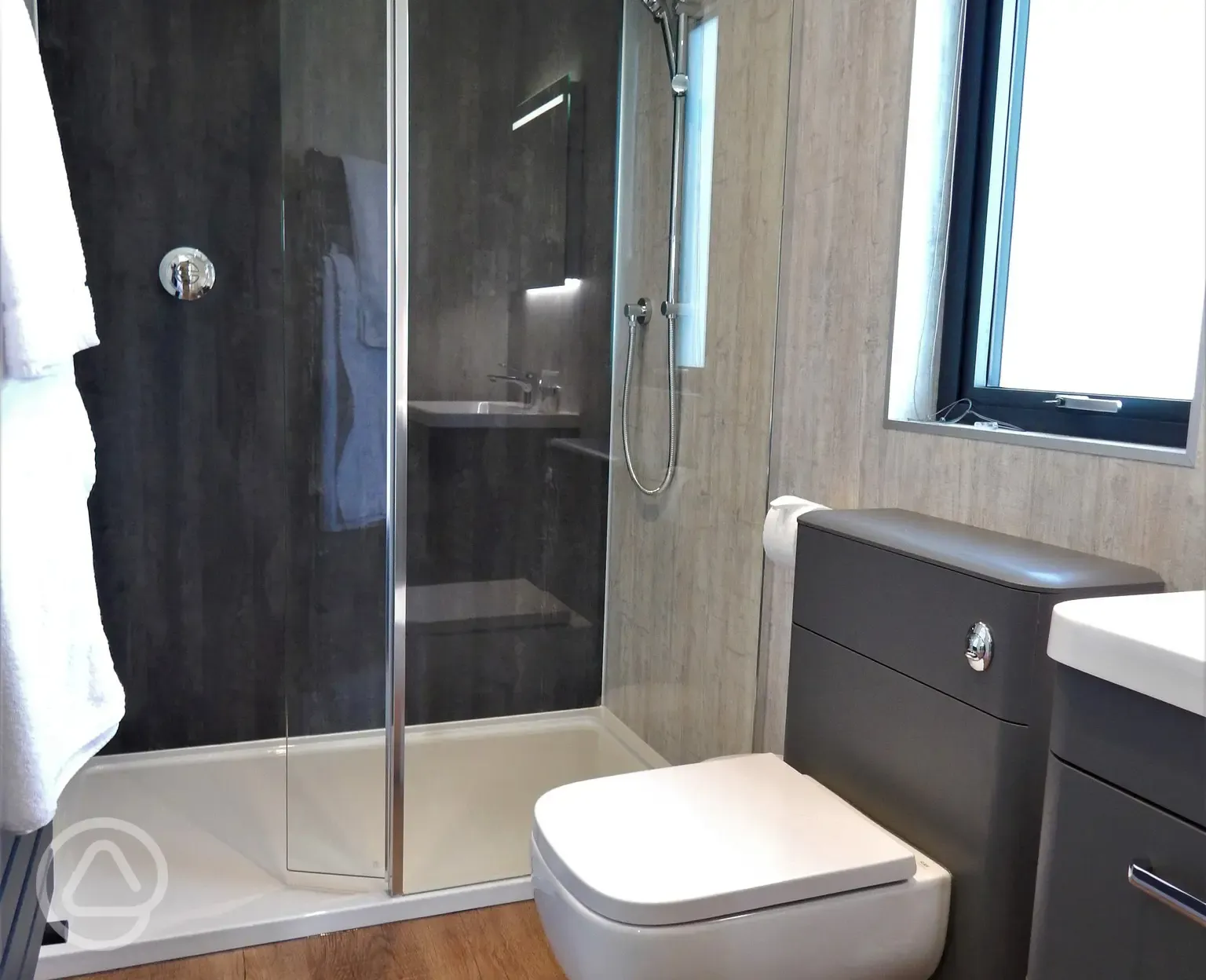 Ensuite glamping lodge bathroom with rainfall shower (towels and robes provided)