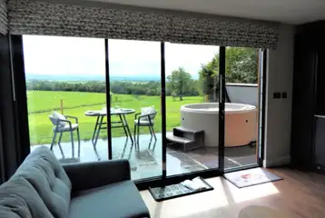 Ensuite glamping lodge living area with country views