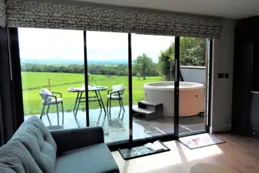 Ensuite glamping lodge living area with country views