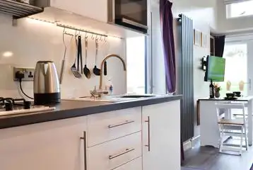 Curlew lodge kitchen with a fridge, kettle, hob, microwave and toaster Curlew lodge kitchen with a fridge, kettle, hob, microwave and toaster