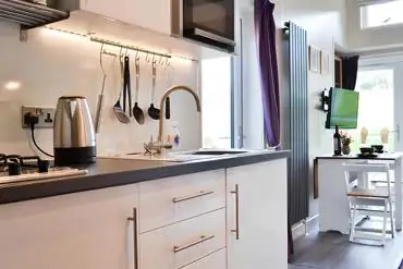 Curlew lodge kitchen with a fridge, kettle, hob, microwave and toaster