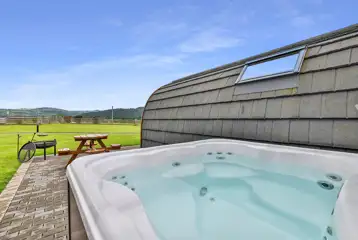 Ensuite glamping pod with a hot tub and a fire pit at Wern Farm Caravan Park Ensuite glamping pod with a hot tub and a fire pit at Wern Farm Caravan Park