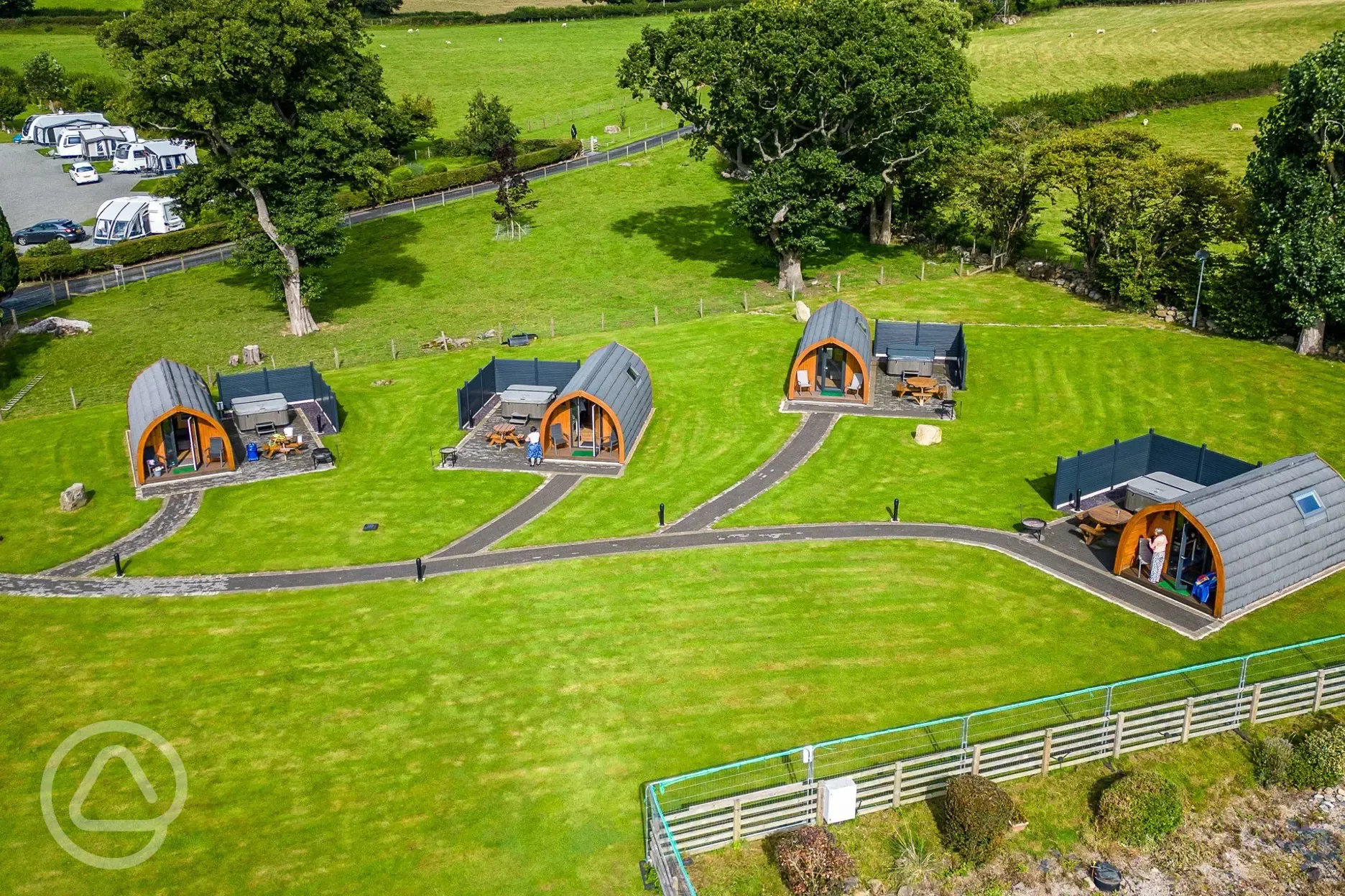 Aerial of glamping pods with hot tubs