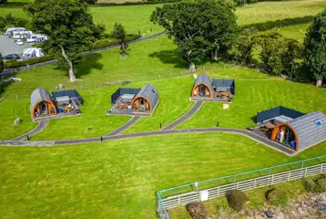 Aerial of glamping pods with hot tubs