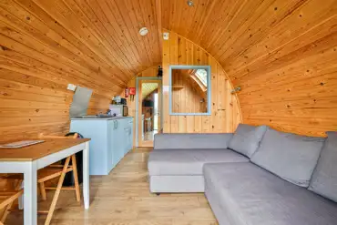 Ensuite glamping pod lounge and dining area with a kitchenette