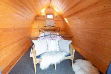 Cosy wooden camping pod interior