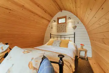 Cosy wooden camping pod interior