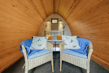 Cosy wooden camping pod interior