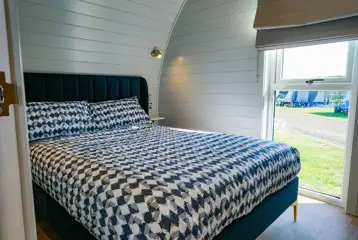 Side entry pod bedroom with a double bed (bedding provided)