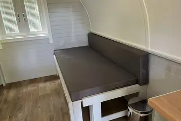 Beds and cooking area in the superior camping pod