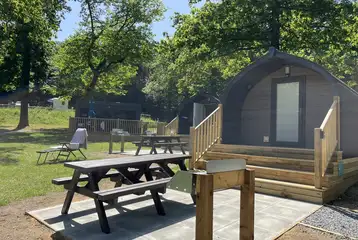 Superior camping pod with its own patio with picnic table and barbecue station