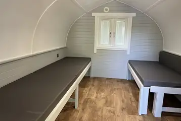 Seating which converts to beds in the superior camping pod