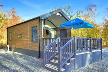 Ensuite glamping cabins with step access and private decks with seating