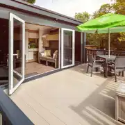 Glamping pod deck area with double glass doors and a box for muddy shoes
