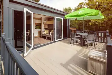Glamping pod deck area with double glass doors and a box for muddy shoes
